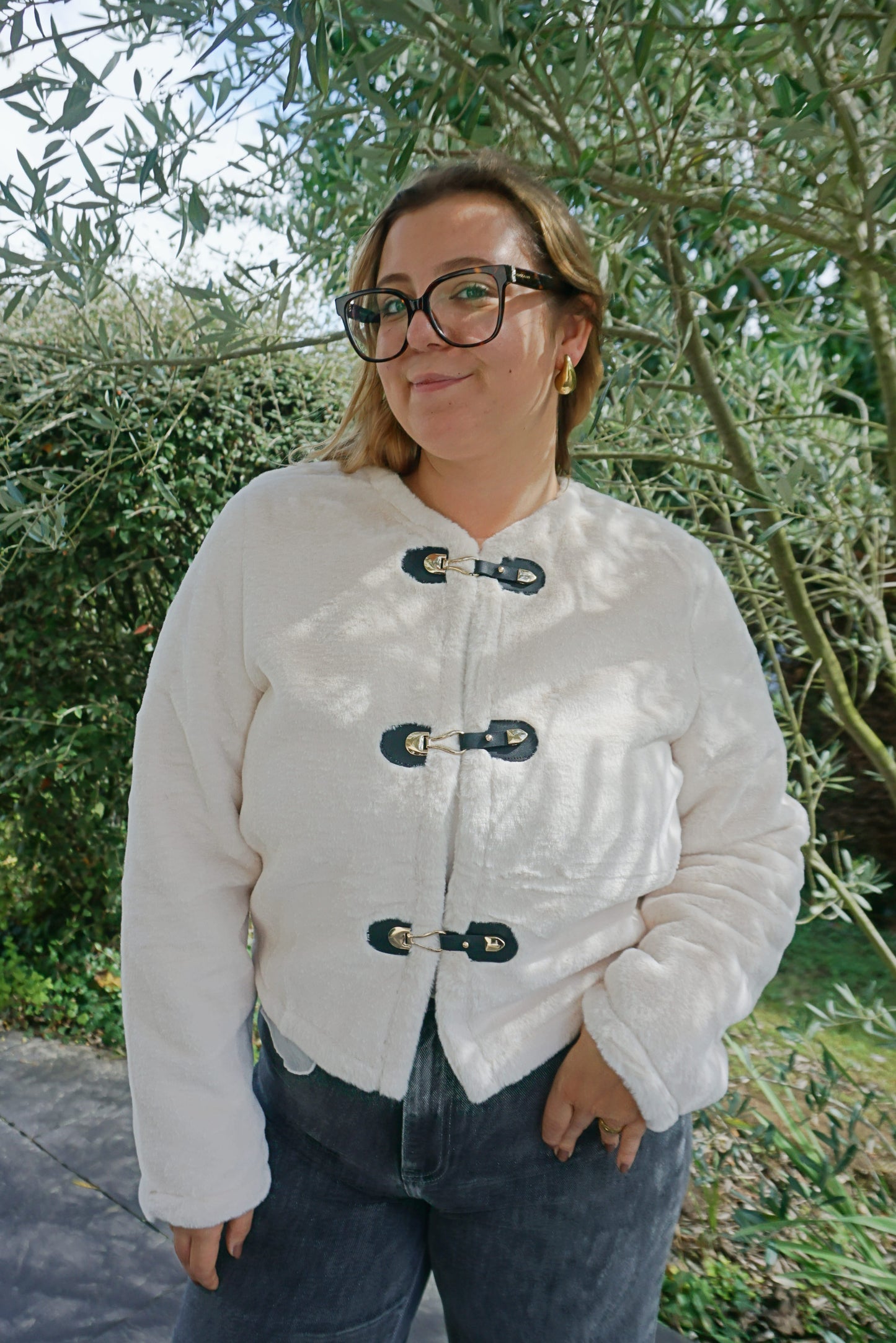 Veste à poils blancs et fermoirs dorés